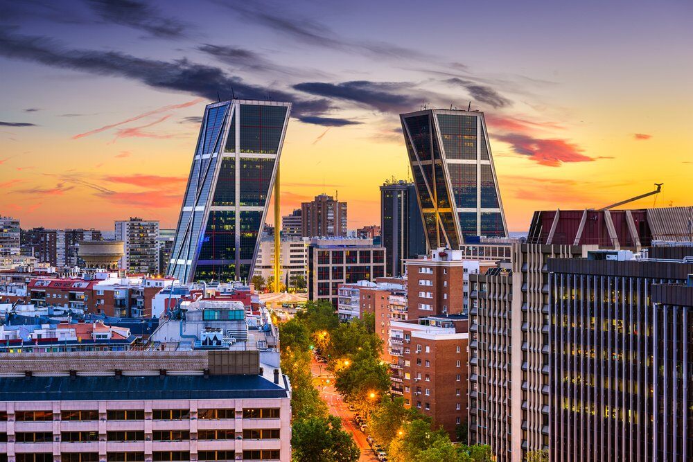 Madrid, Spain financial district skyline at twilight viewed towards the Gates of Europe.
