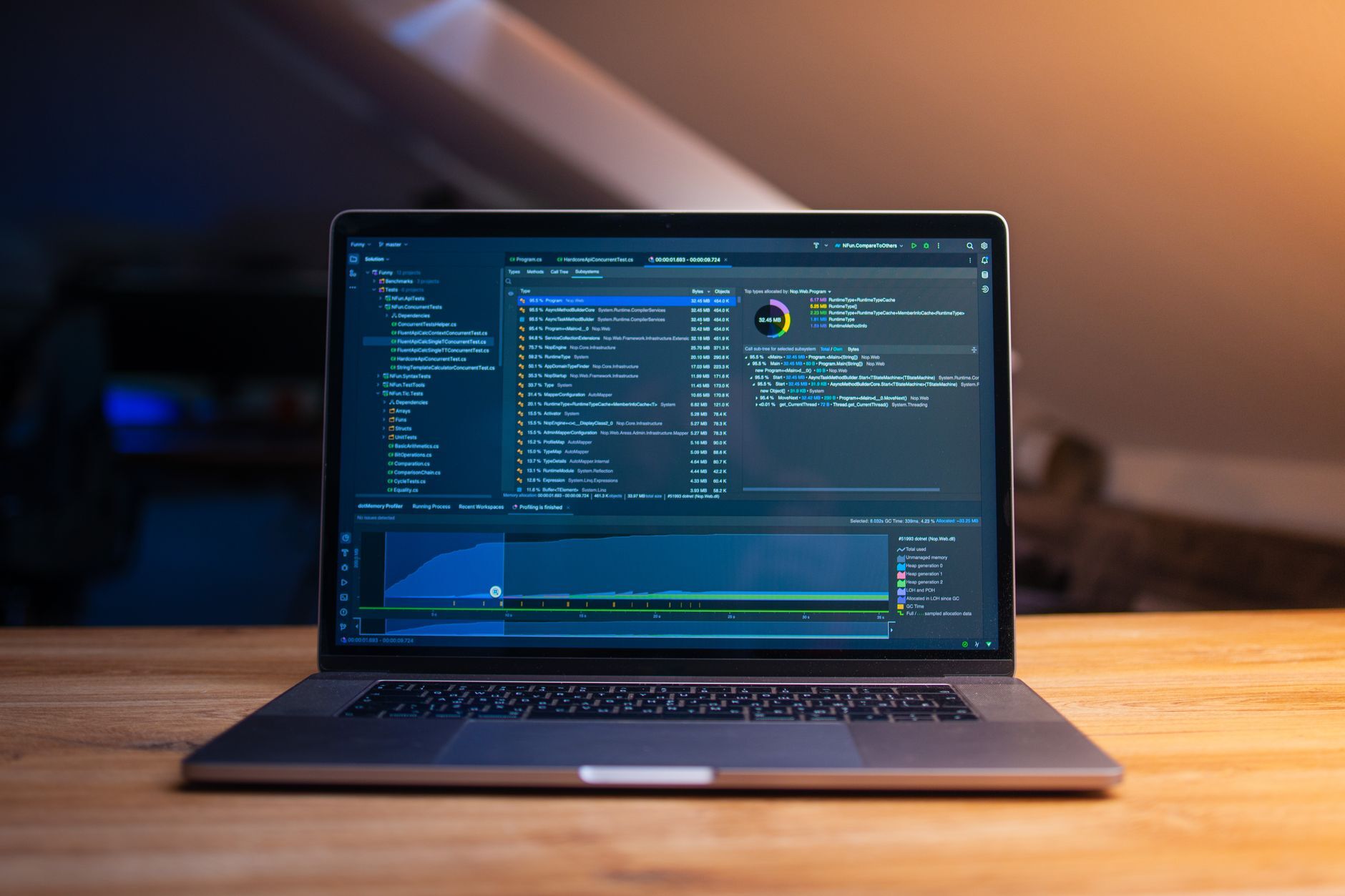 Laptop displaying code on a wooden desk