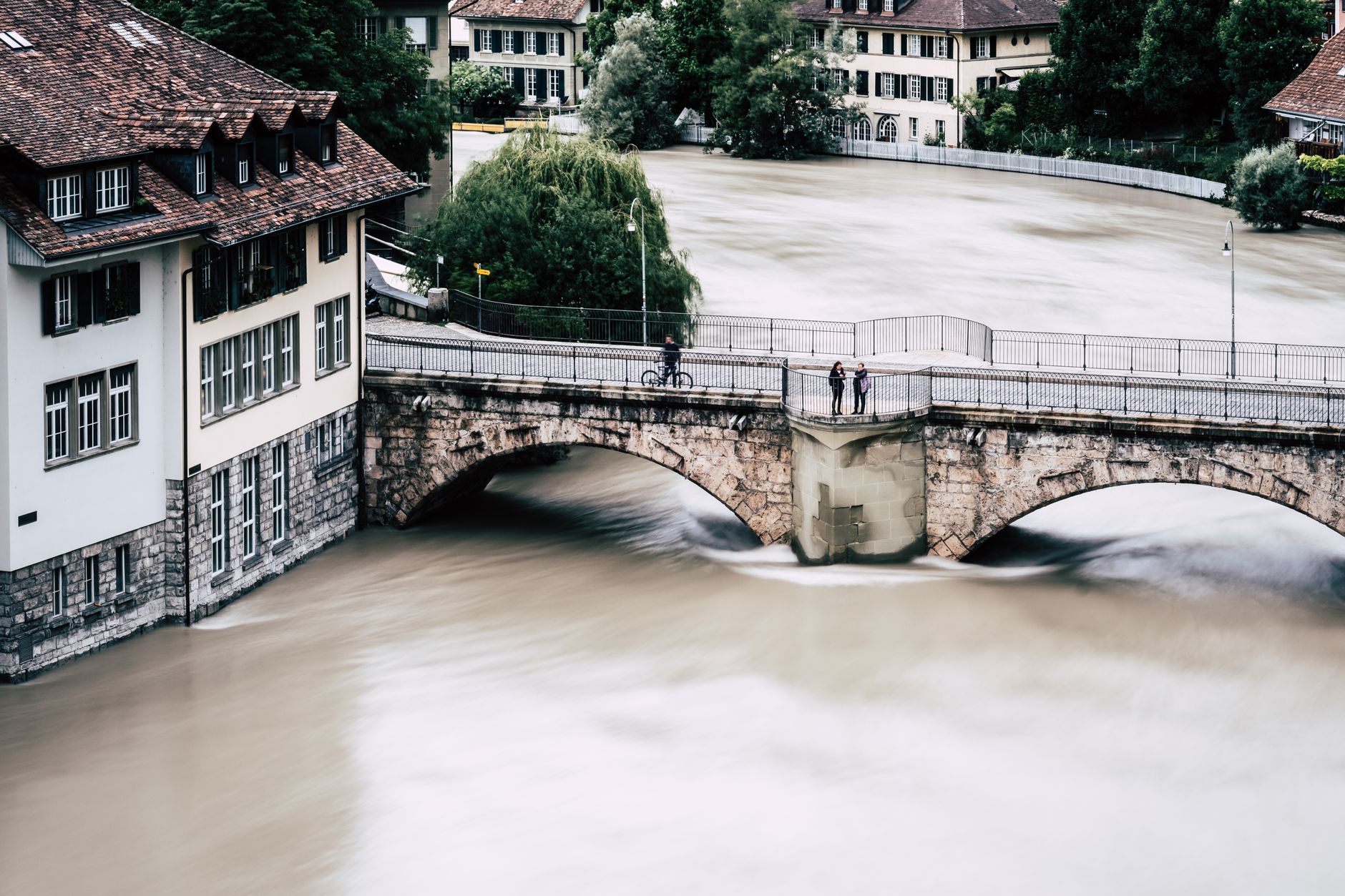 Historic bridge over a river in flood in Bern, Switzerland